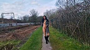 Beautiful brunette gets naked and urinates outdoors