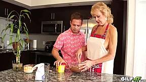 A young and energetic man seduces a mature woman in her kitchen