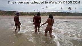 Beautiful woman having sex on the beach in front of everyone who is watching