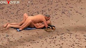A passionate beach encounter between an older man and a hot milf on the ocean shore