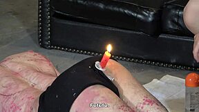 An Asian sub gets his ass spanked with a burning candle under the control of a Dominatrix