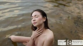 A young woman with a slim built and small bosom has an outdoor orgasm