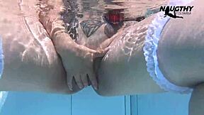 A sexy brunette enjoys solo pleasure with a blue dildo by the pool