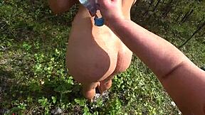 Lesbian fun in nature with a strapon