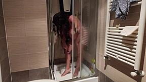 A hot MILF with big boobs shaves her pussy in the shower