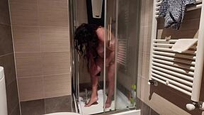 A hot MILF with big boobs shaves her pussy in the shower