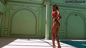A gorgeous Russian girl in a swimsuit is enjoying the pool