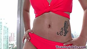 A trans babe caresses her ass and plays with a dildo