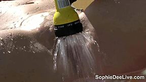 Sophie Dee’s big tits in a tiny bikini for solo fun